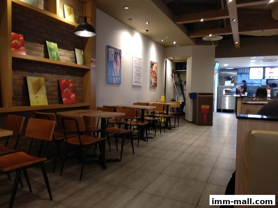 Interior view of a Burger King restaurant with seating, shelves, and a service counter.