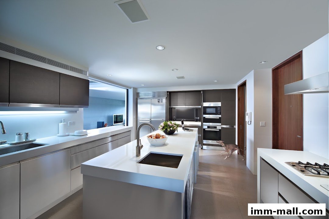 A modern, spacious kitchen with a large island, stainless steel appliances, and sleek cabinetry.