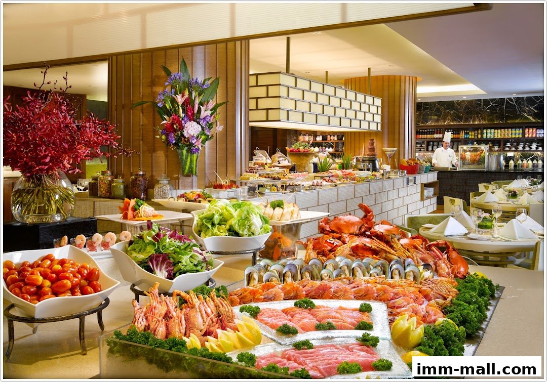A lavish buffet spread featuring seafood, salads, and desserts with a chef in the background.