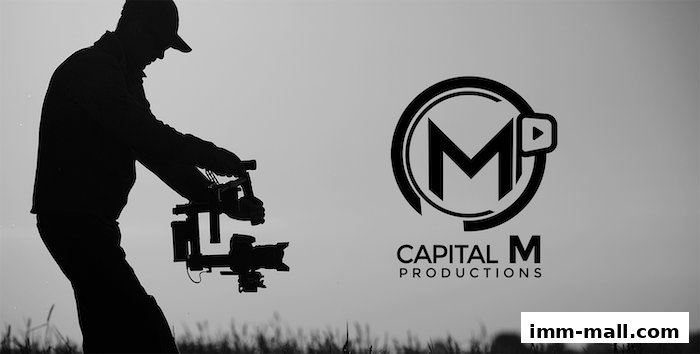 A silhouette of a filmmaker holding a camera gimbal with the Capital M Productions logo.