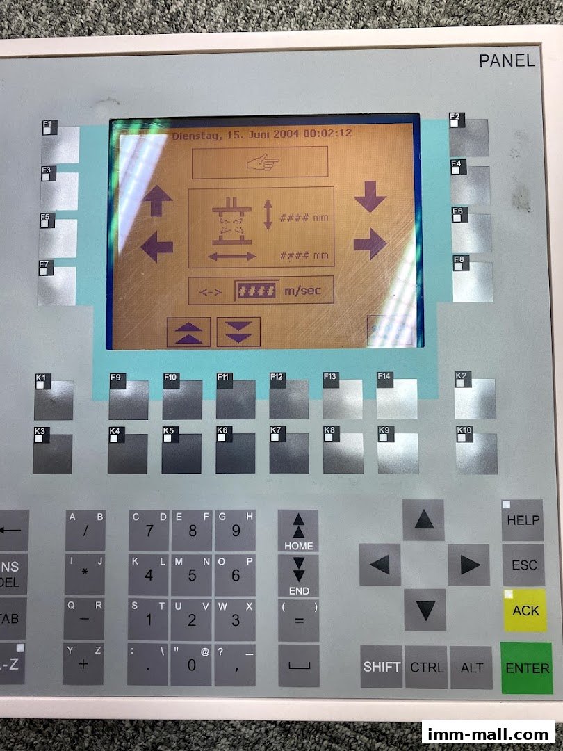A close-up view of a control panel with a digital display and numerous buttons.