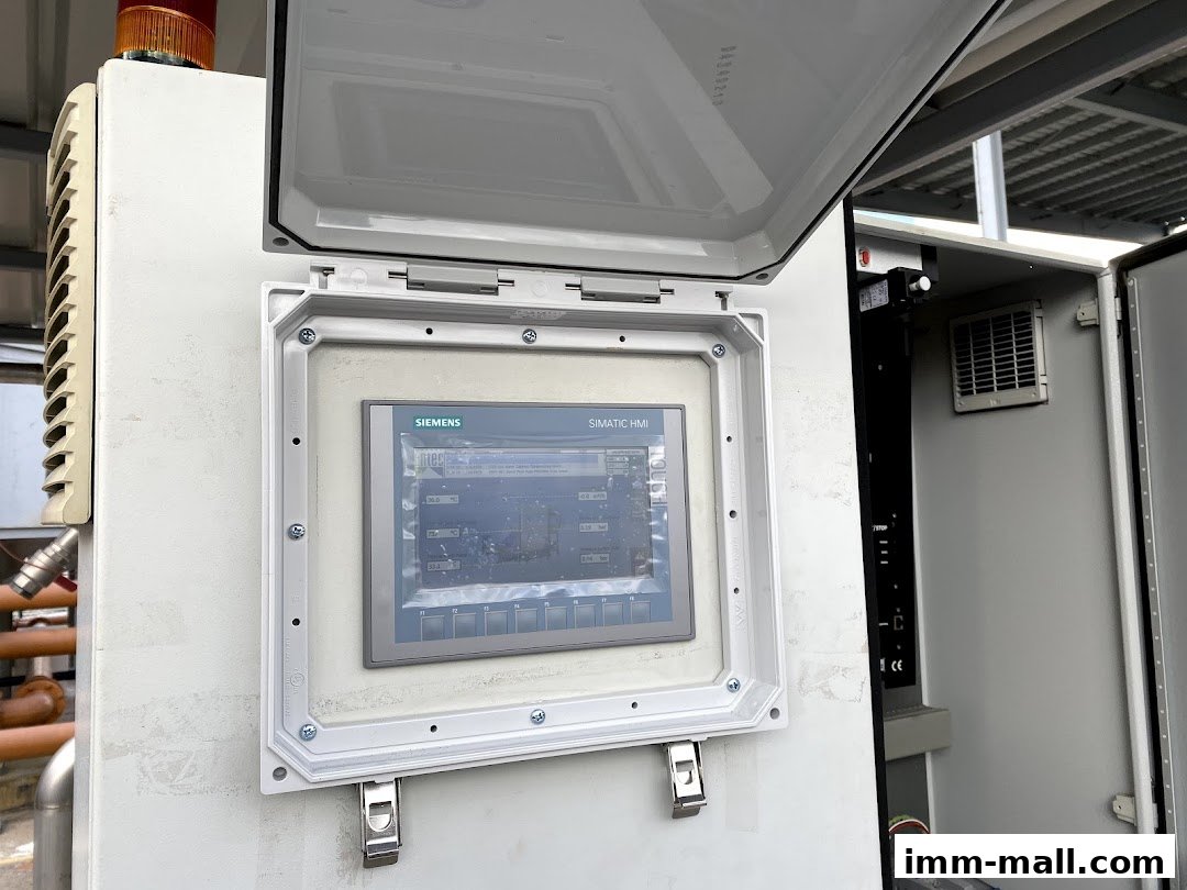 A close-up of an industrial control panel with a Siemens SIMATIC HMI touchscreen display.