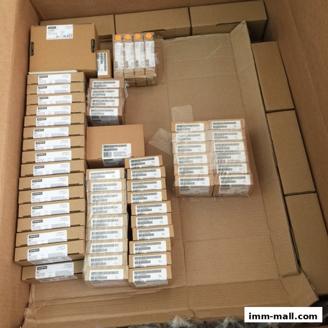 A large quantity of electronic components, likely industrial automation parts, are neatly organized in cardboard boxes.