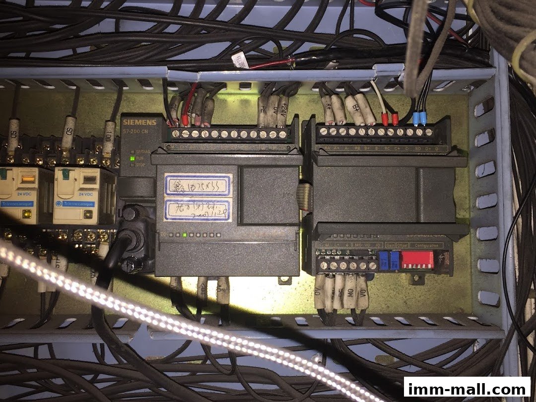 Close-up view of industrial electrical control panel with Siemens S7-200 CN components.