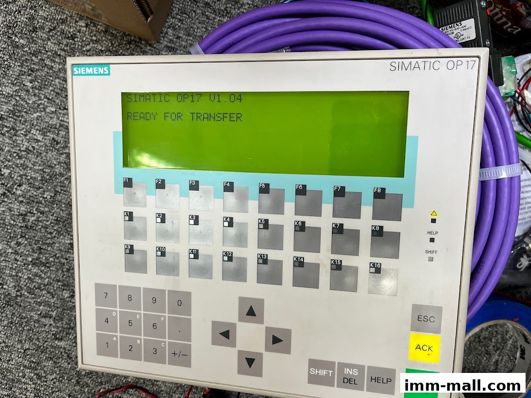 A Siemens SIMATIC OP17 control panel with a green display and various buttons.