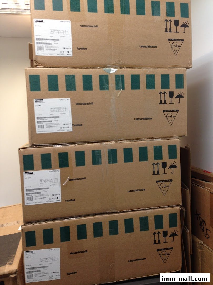 Stack of cardboard boxes with Siemens SIMATIC IPC labels and shipping information.
