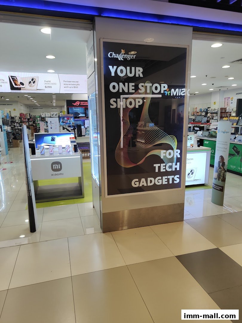 Challenger IMM shop front with a large advertisement for tech gadgets.