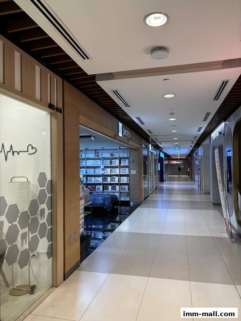 A view down a shopping mall corridor with several shop entrances visible.