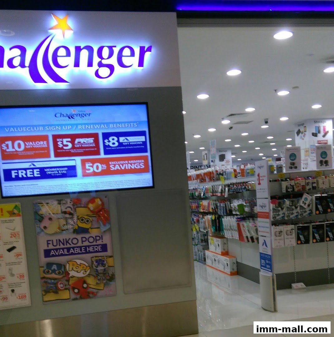 Challenger store entrance with a digital display showing promotions and a Funko Pop poster.
