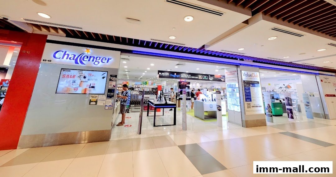 The entrance of Challenger IMM electronics store, showcasing various gadgets and promotions.