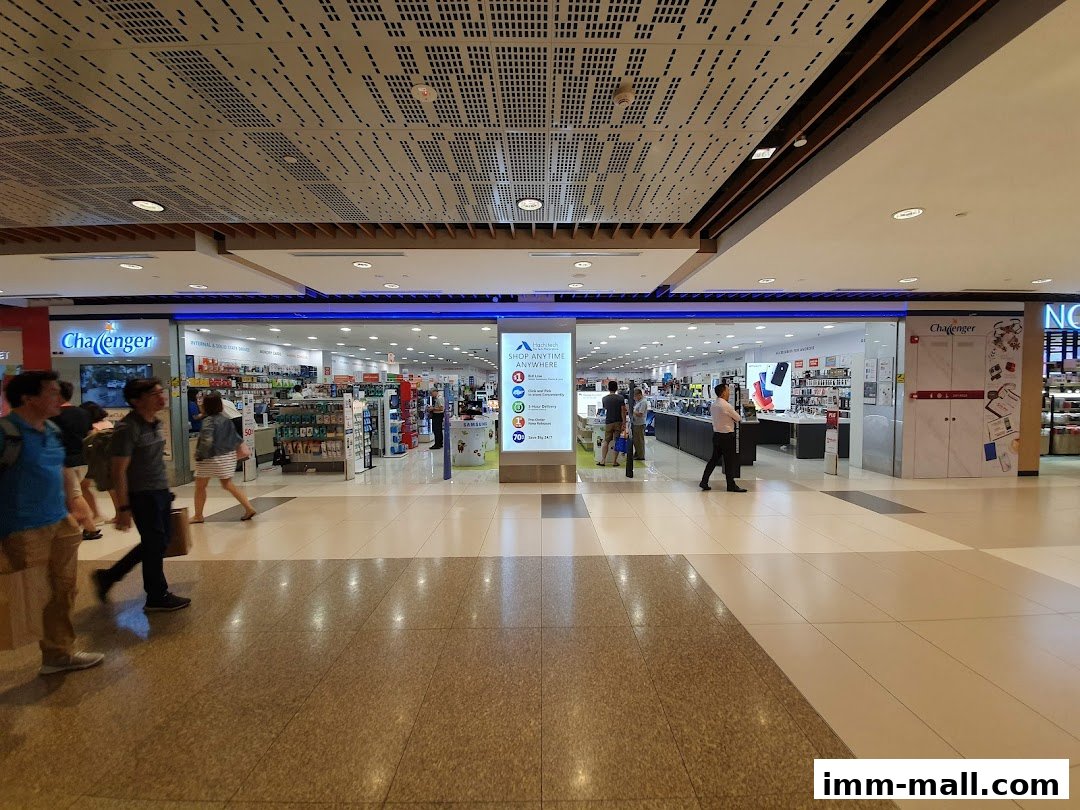 The exterior of a Challenger electronics store with customers browsing inside.