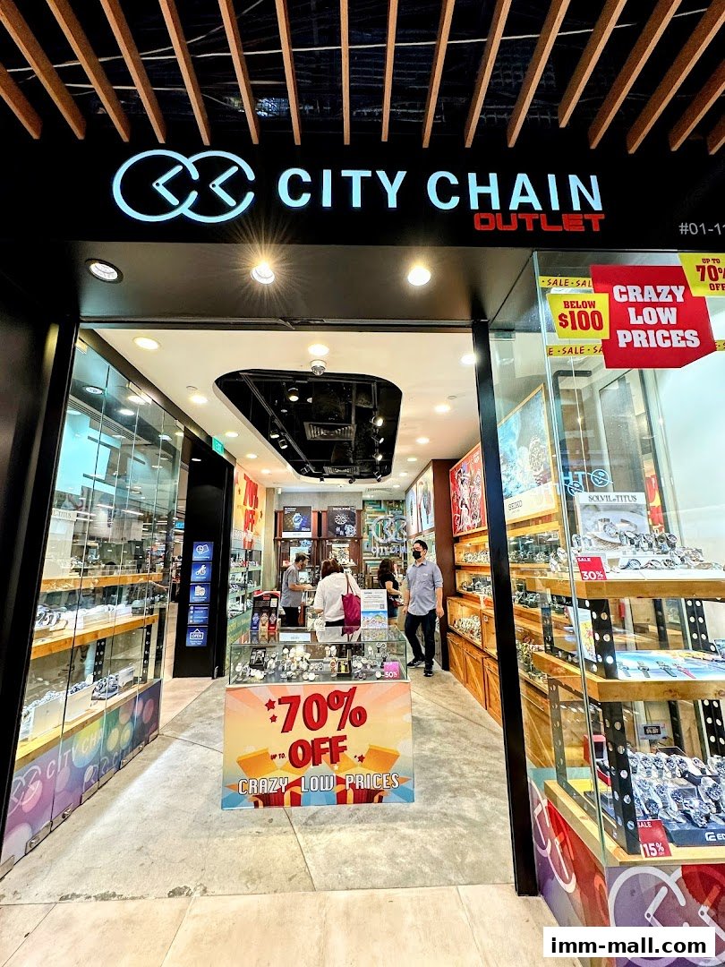 City Chain Outlet store entrance with watches displayed and sale signs.