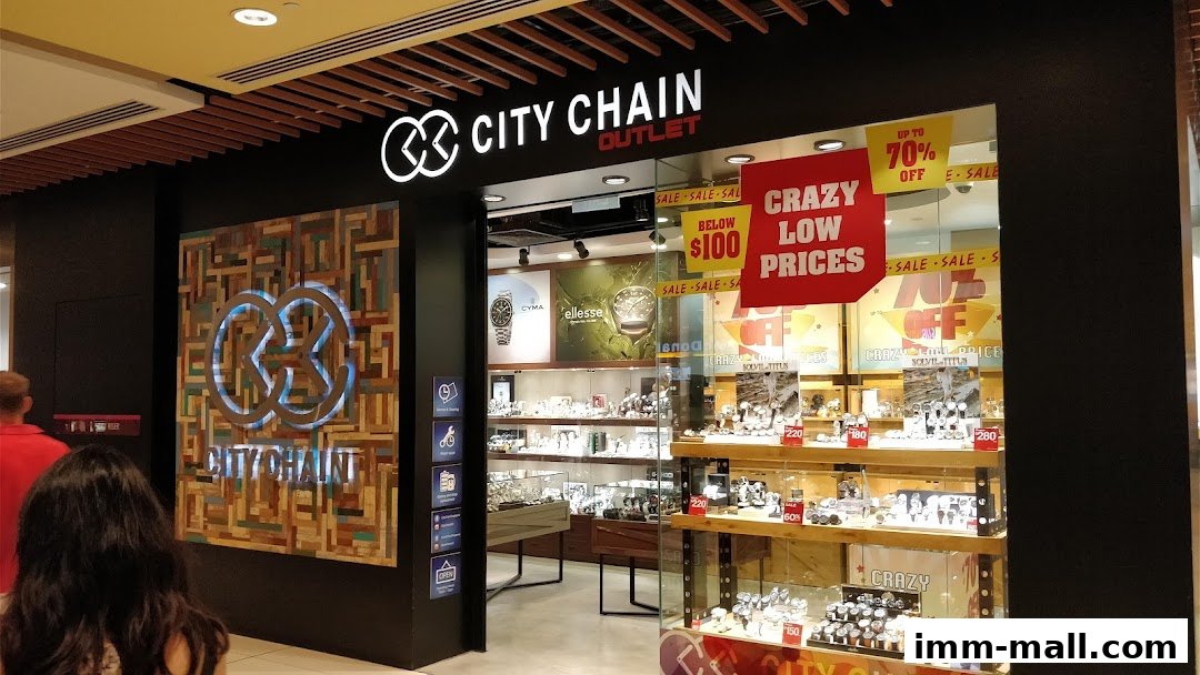 City Chain Outlet store with watches displayed in windows and sale signs.