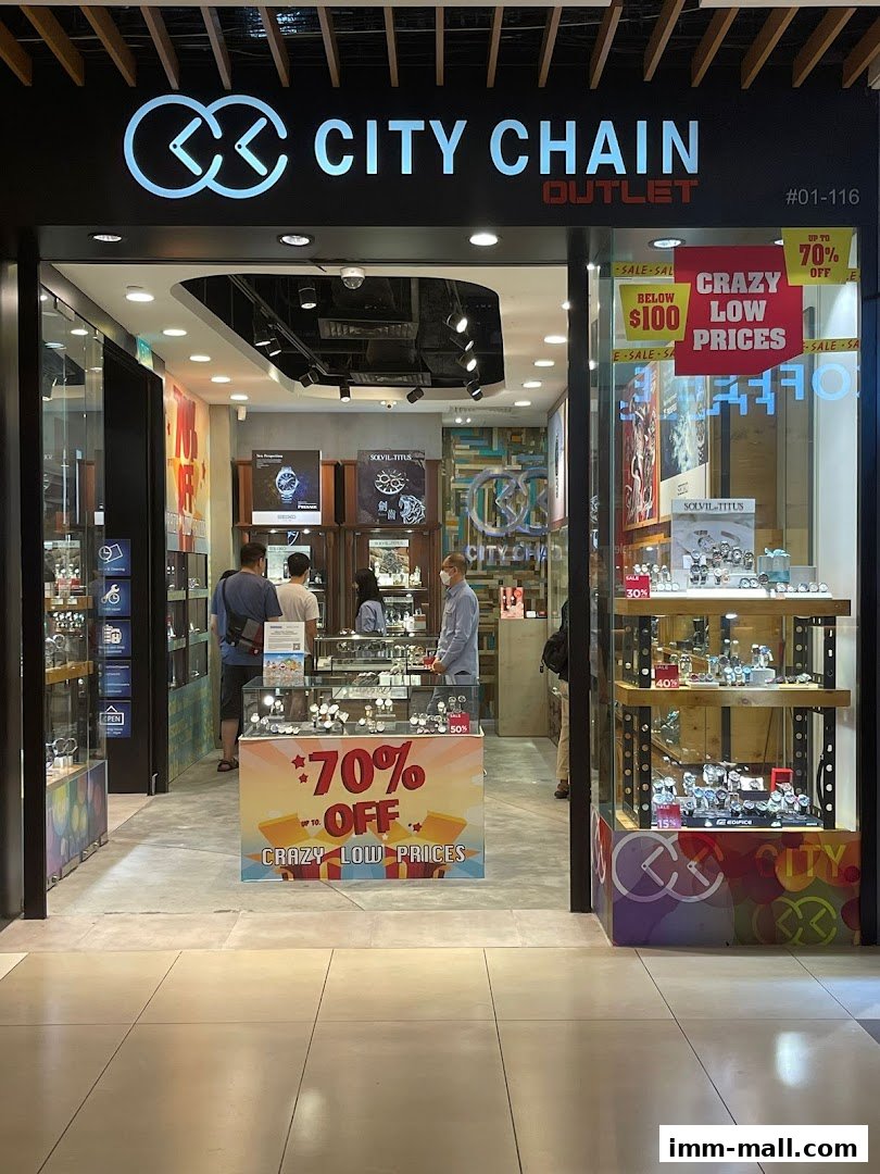 City Chain Outlet store entrance with watches displayed and sale signs.