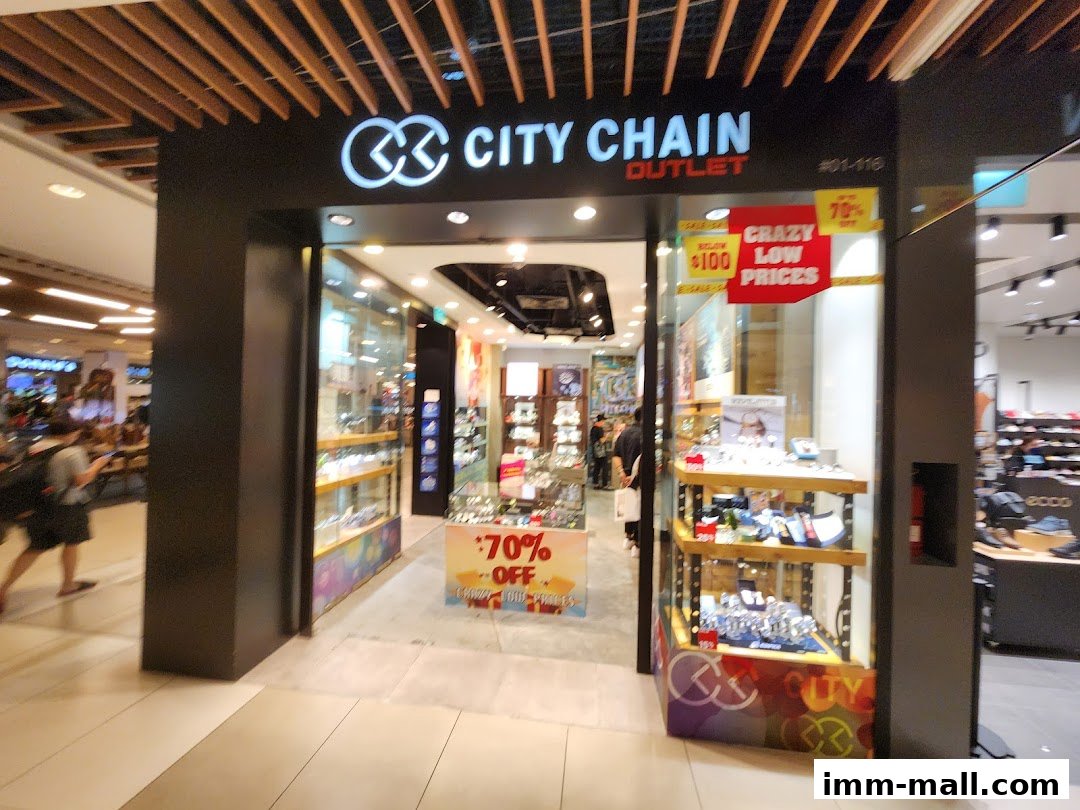 The City Chain Outlet store entrance, featuring watches and sale signs.