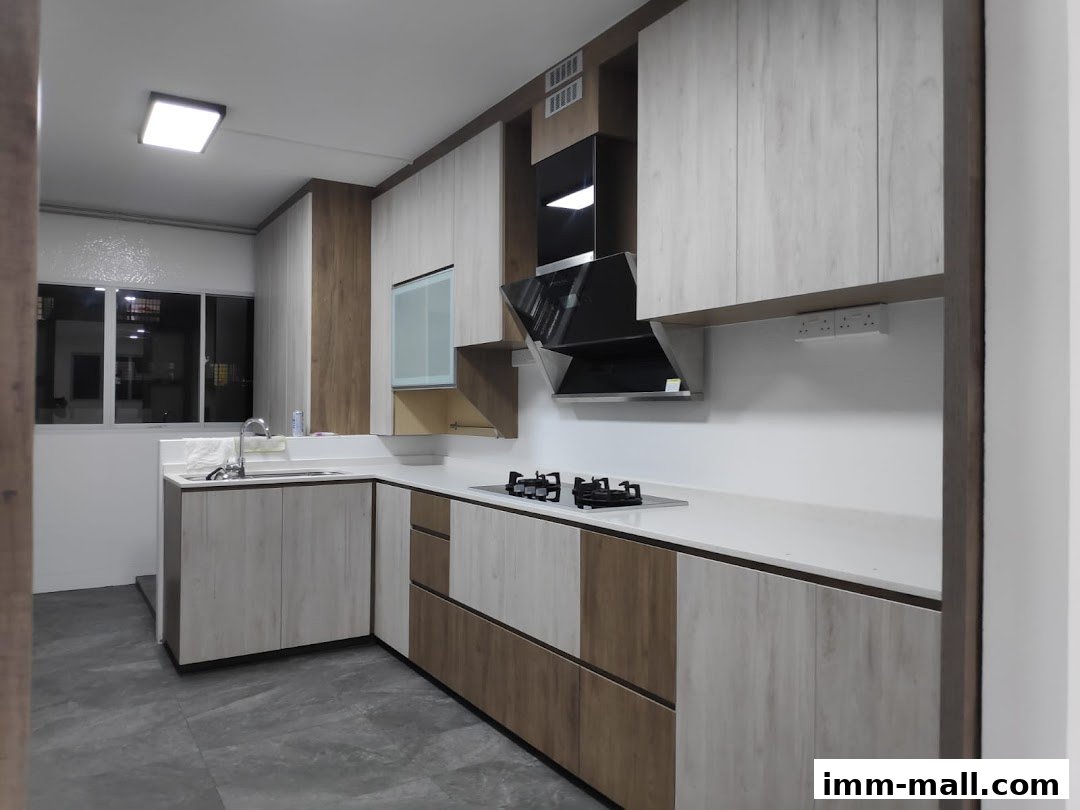A modern kitchen with light wood cabinets, a sleek black range hood, and a white countertop.
