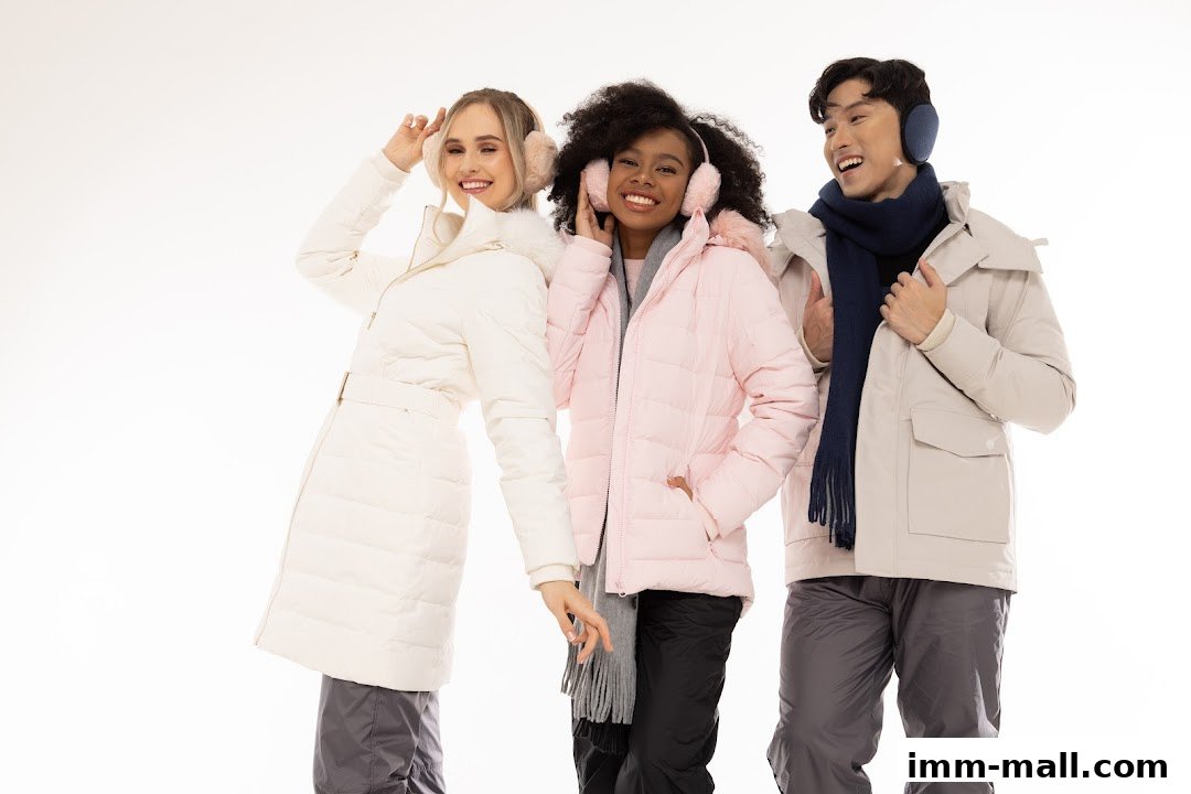 Three smiling people wearing winter jackets and earmuffs against a white background.