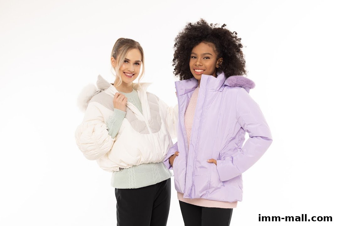 Two smiling women modeling stylish puffer jackets in cream and lavender.