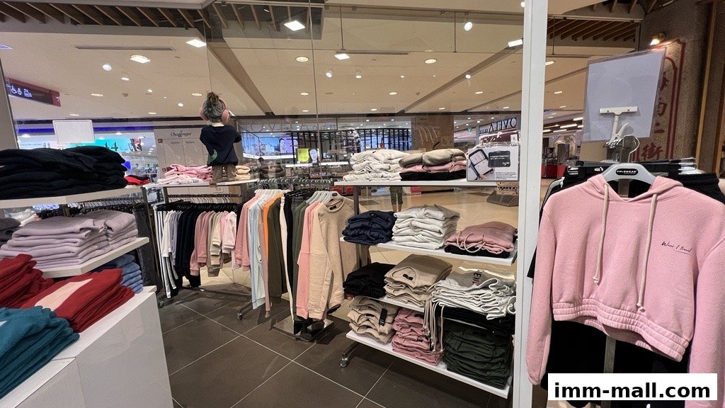 Interior view of a clothing store displaying stacks of folded sweaters and hoodies.