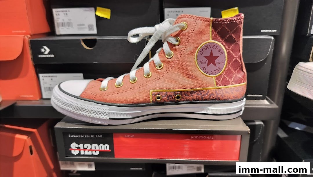 A close-up of a stylish Converse Chuck Taylor All Star sneaker with a unique color block design.