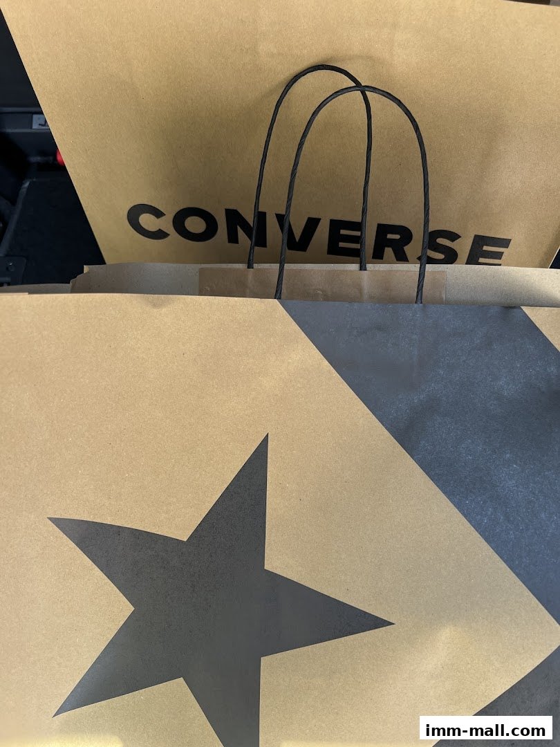 Two Converse shopping bags, one with the brand name and the other with a star pattern.