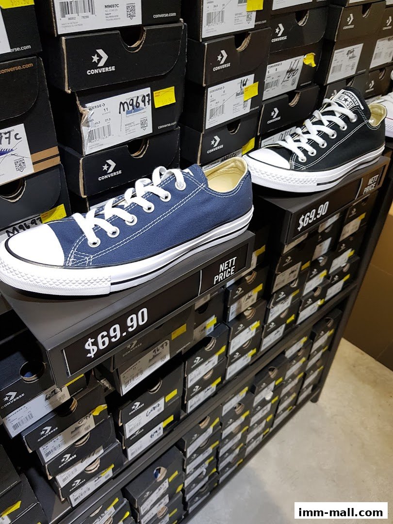 A display of Converse shoes in their original boxes, with two pairs prominently featured.