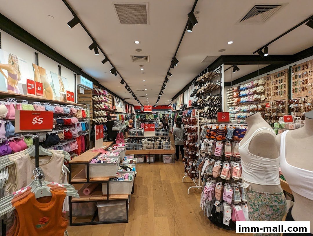 Interior view of a Cotton On store showcasing apparel and accessories, with displays of bras, socks, and mannequins.