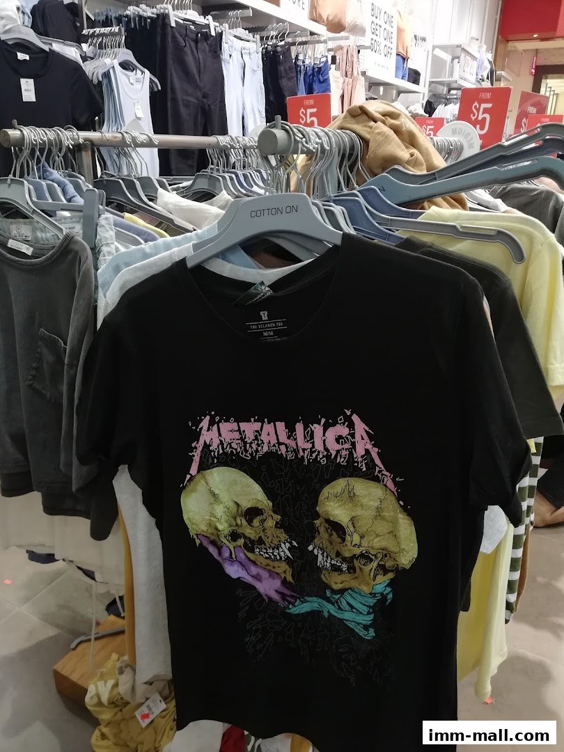 A rack of t-shirts, including a black Metallica t-shirt, at Cotton On.