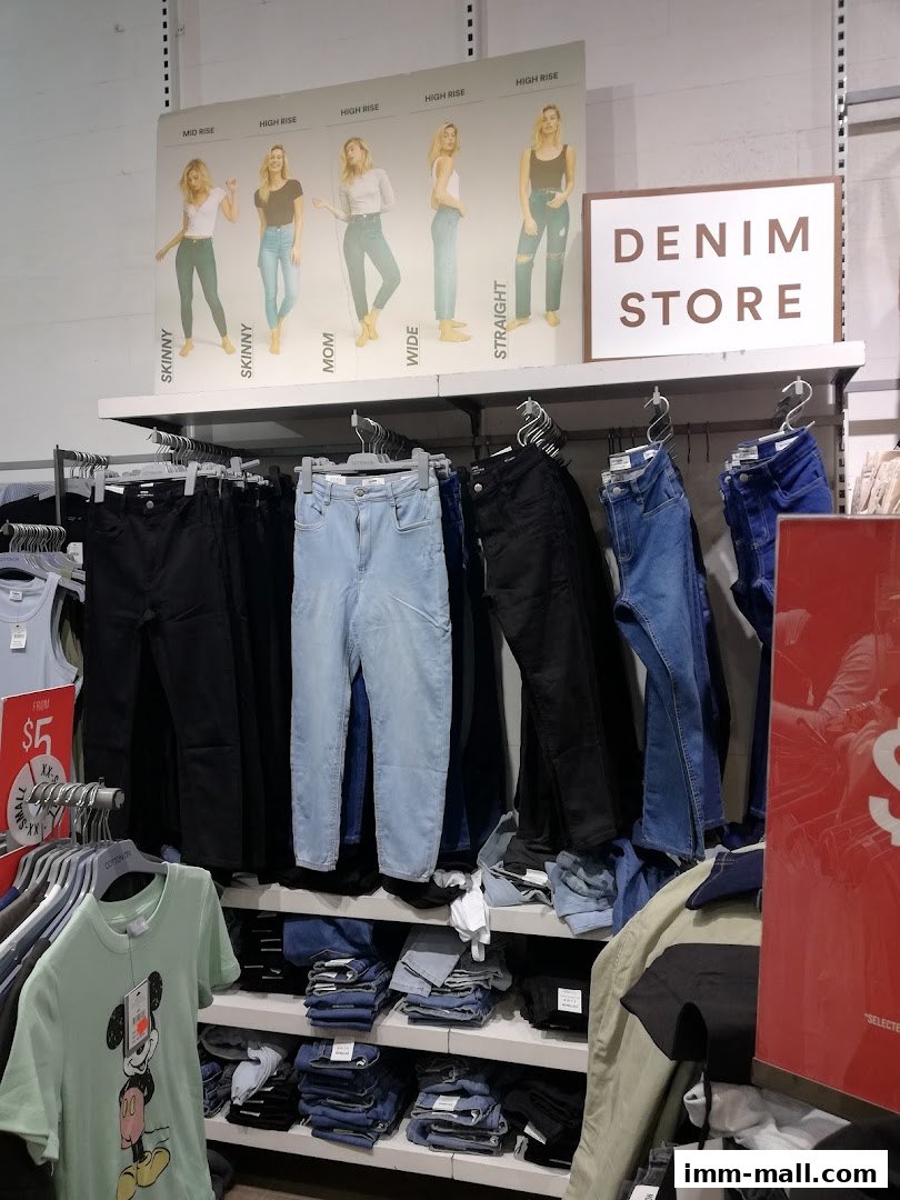 A display of various styles of jeans and t-shirts in a retail store.