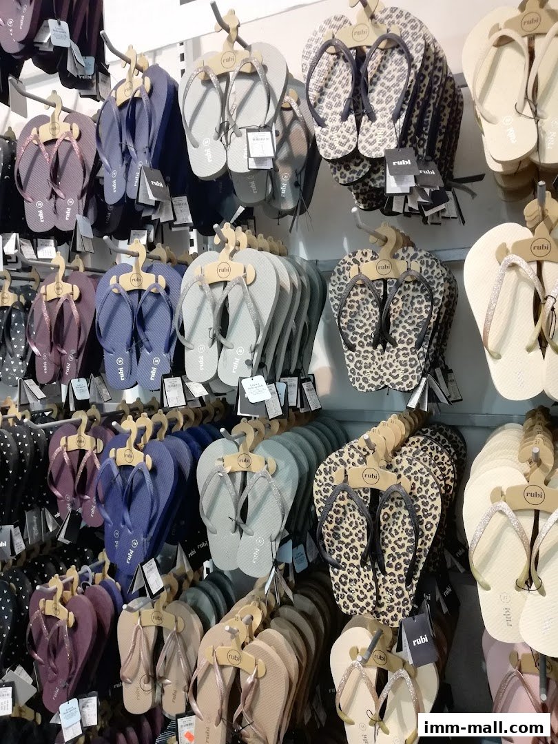 A wall display showcasing a variety of flip-flops in different colors and patterns.