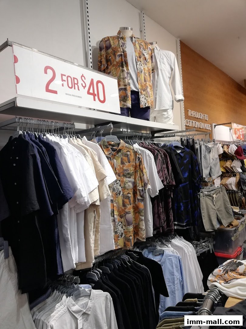 A display of men's shirts and clothing on racks, with a '2 for $40' sale sign.
