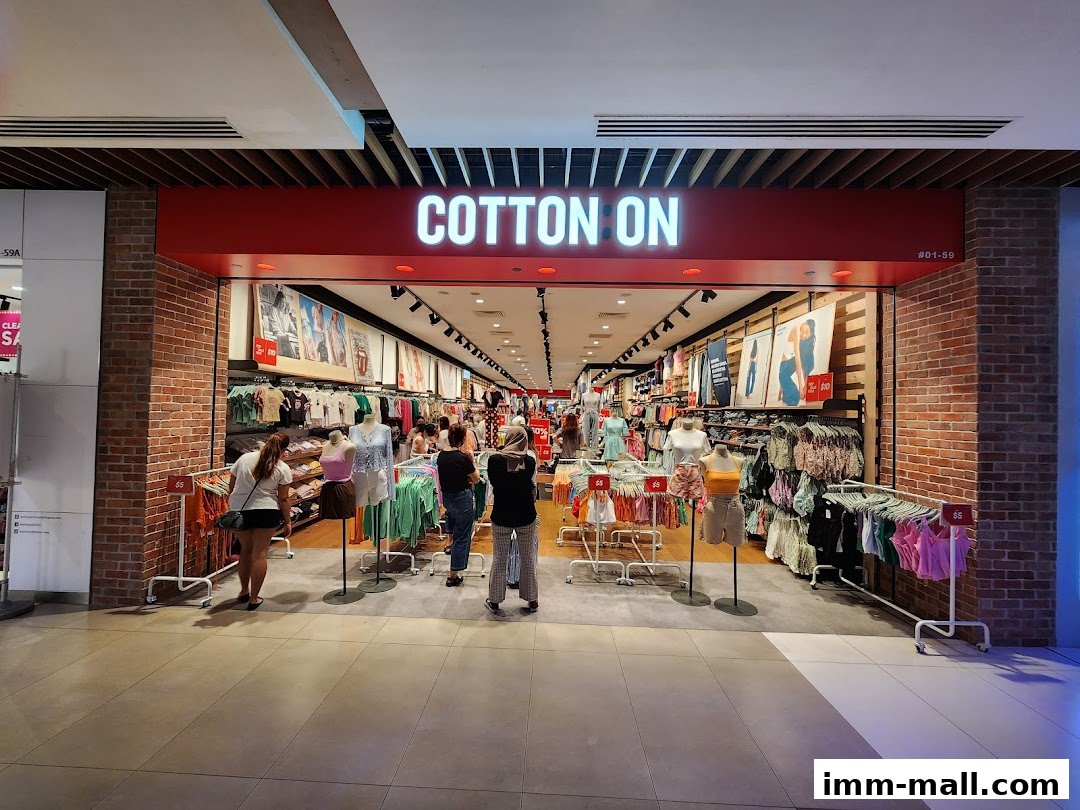The entrance of Cotton On IMM Outlet, showcasing a variety of clothing and mannequins.