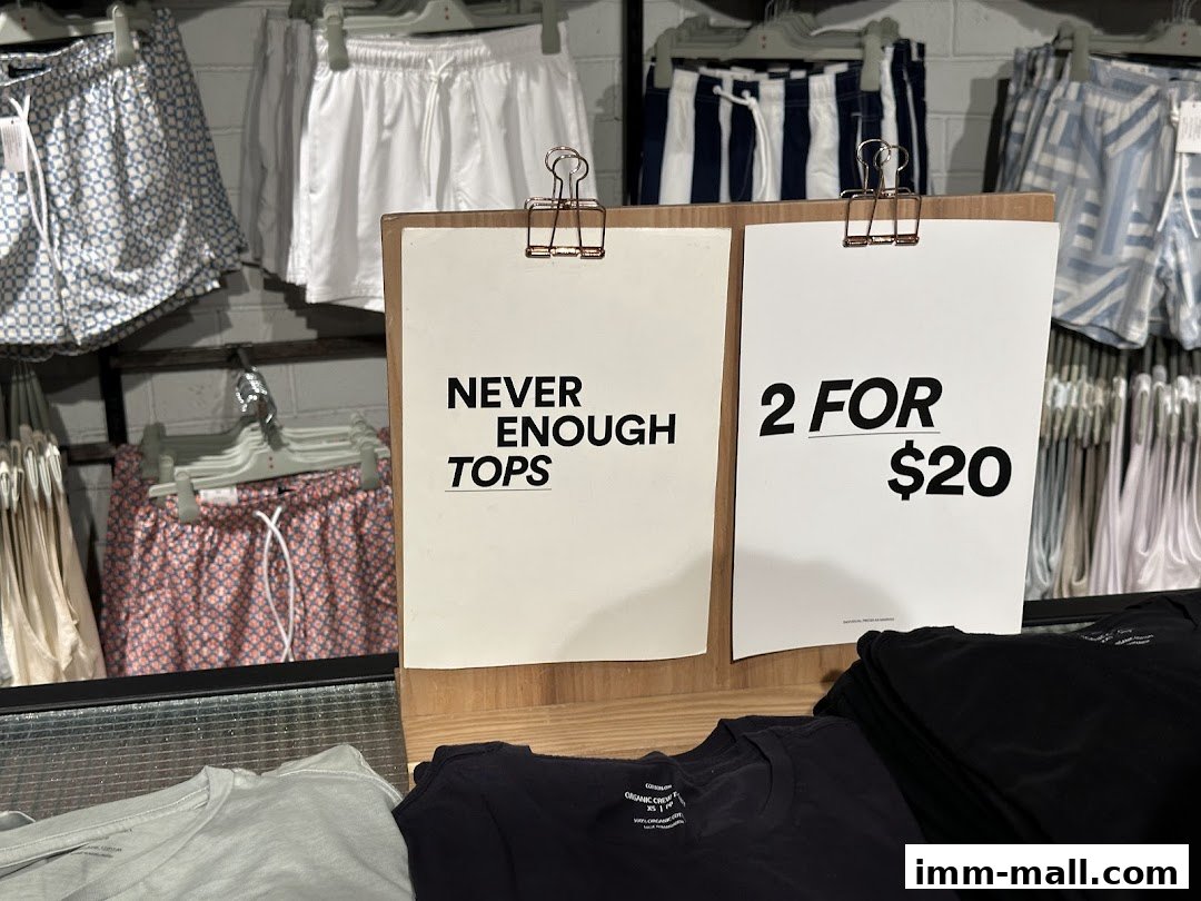 A display of shorts and t-shirts with promotional signs for a clothing store.
