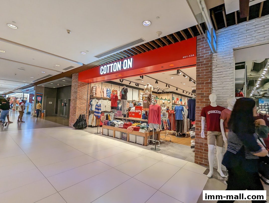 The Cotton On IMM Outlet store entrance with mannequins and clothing displays.
