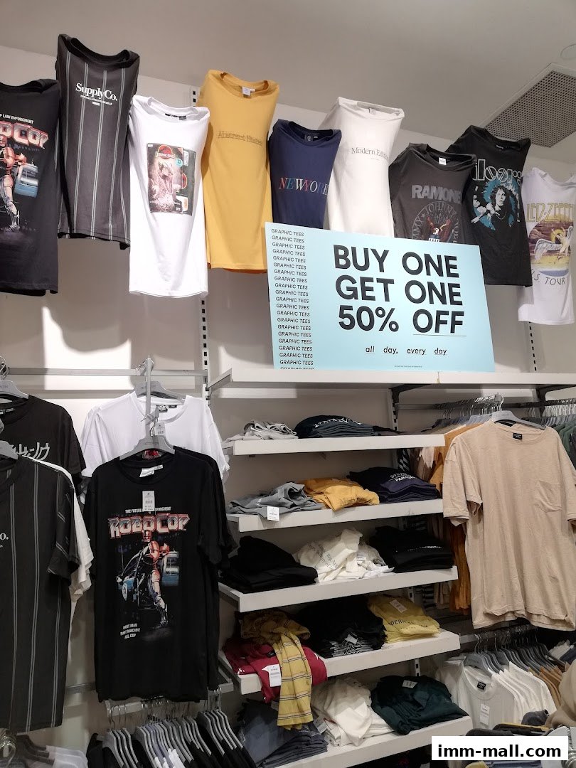 A display of graphic t-shirts with a 'Buy One Get One 50% Off' promotion.