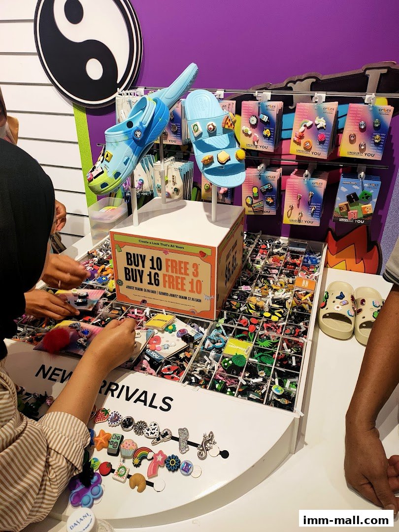 A display of Crocs shoes and Jibbitz charms with a promotional offer.