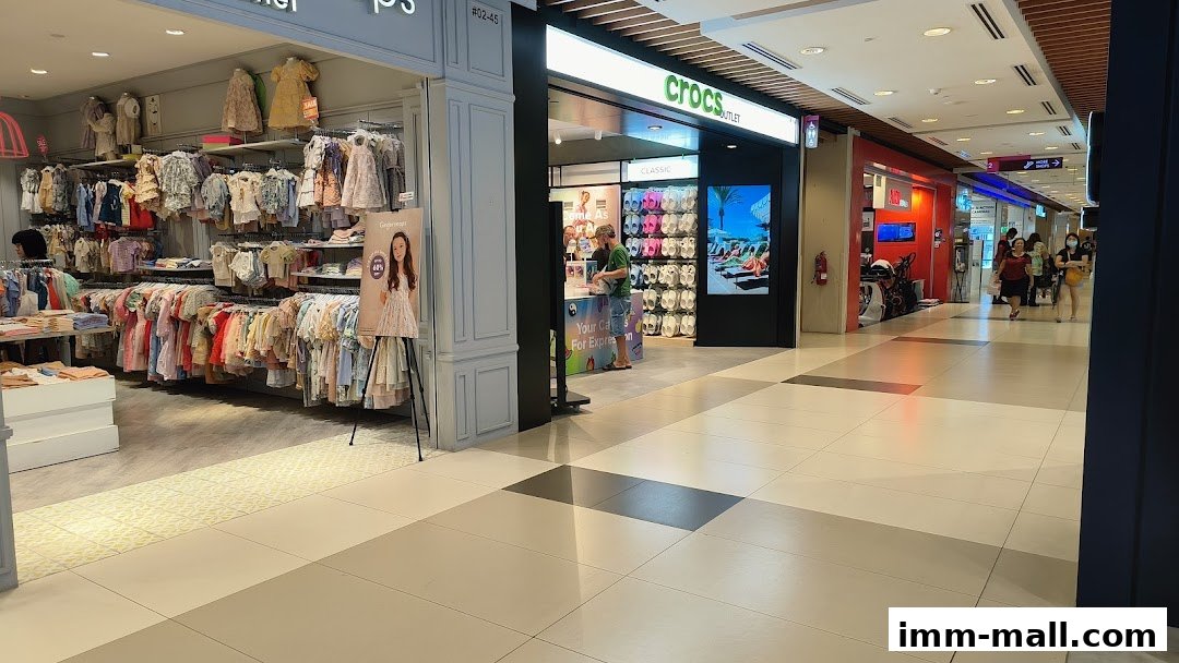 The Crocs outlet store entrance with colorful footwear displayed inside and a person at the counter.