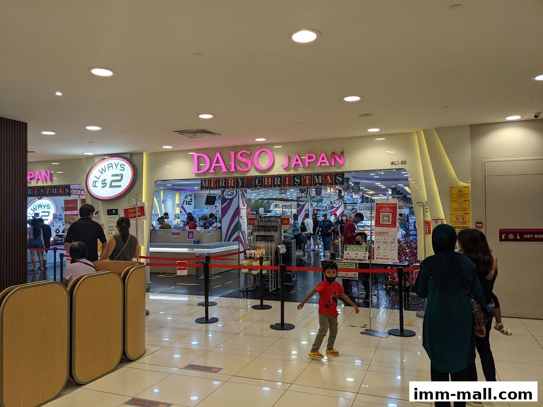 The entrance to a DAISO JAPAN store with people queuing and festive Christmas decorations.