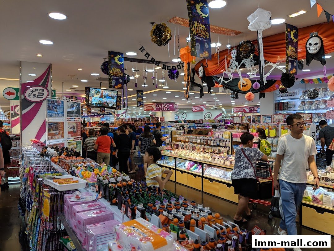 Interior of a DAISO store decorated for Halloween with many shoppers browsing.