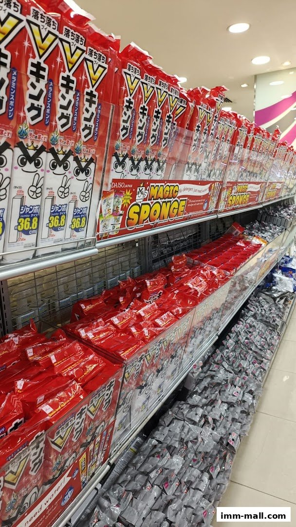 Shelves stocked with cleaning sponges and other household items from DAISO.