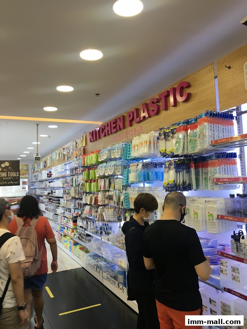 Customers browse a wide selection of kitchen plasticware and household items at DAISO.