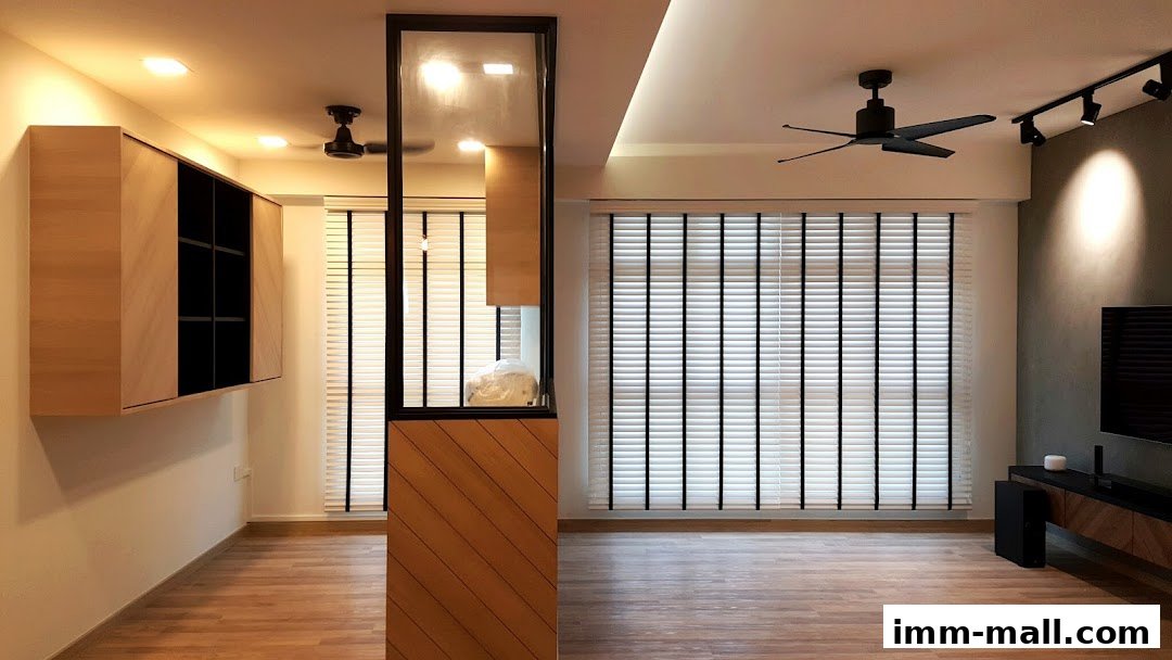 A modern living room interior with wooden cabinets, blinds, and a ceiling fan.