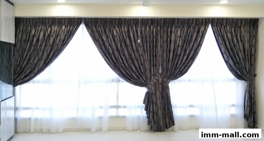 A room interior featuring stylish dark grey curtains with a wave pattern and sheer white curtains.
