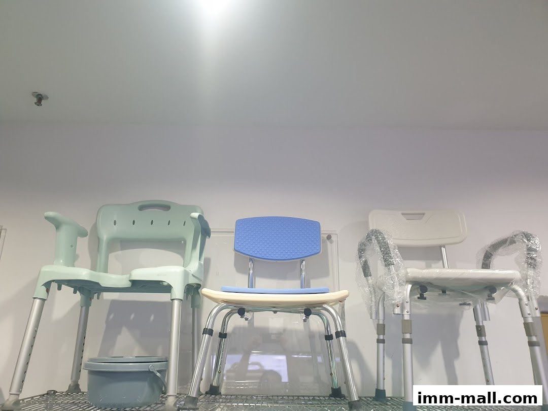 Three shower chairs with backrests and armrests are displayed on a shelf.