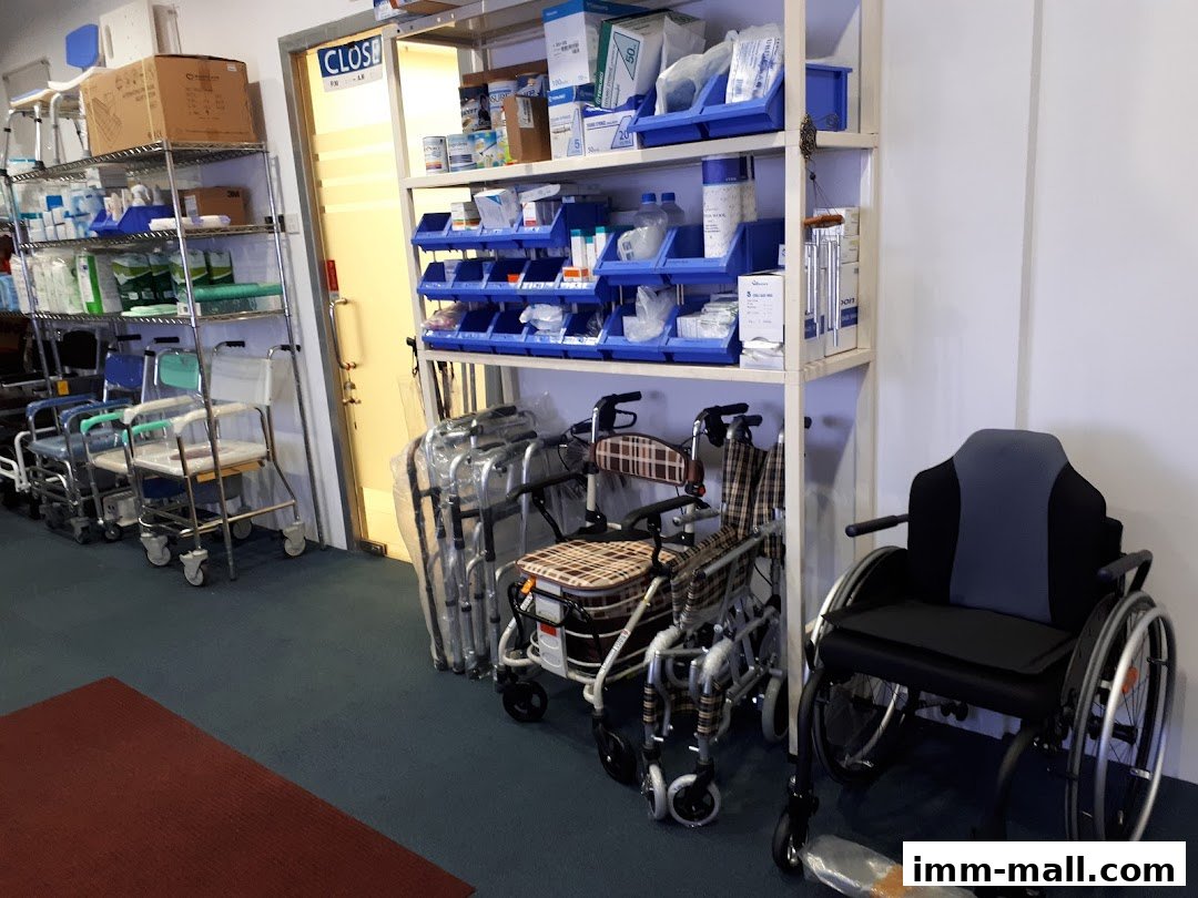 A shop interior displaying various mobility aids like wheelchairs, walkers, and shower chairs, along with medical supplies.