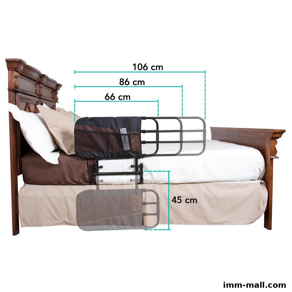 A bed rail with dimensions shown, attached to a wooden bed with pillows.