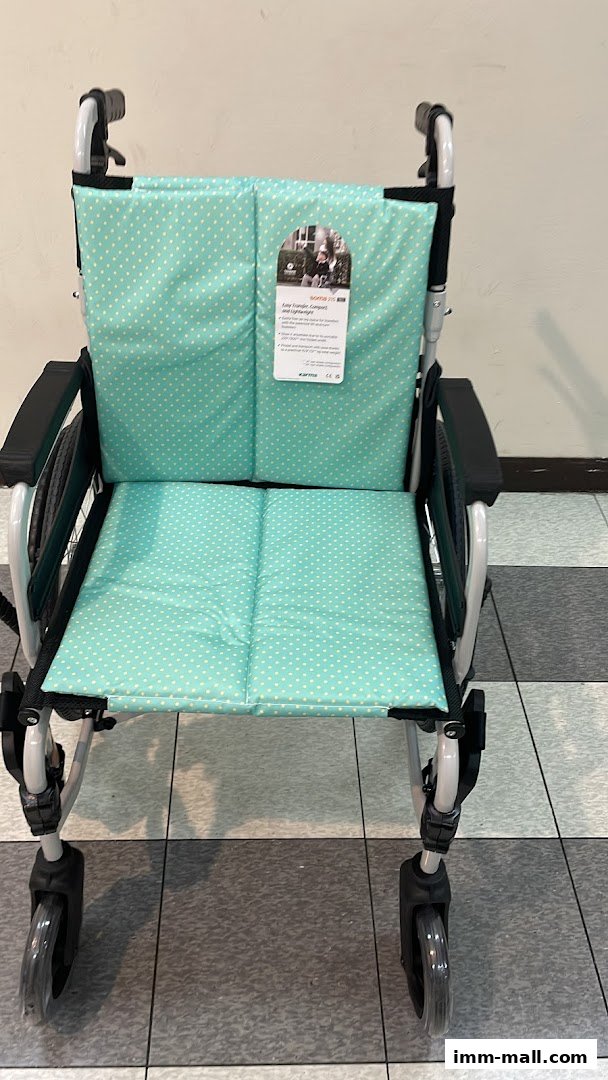 A light blue polka dot wheelchair with a product tag attached to the backrest.