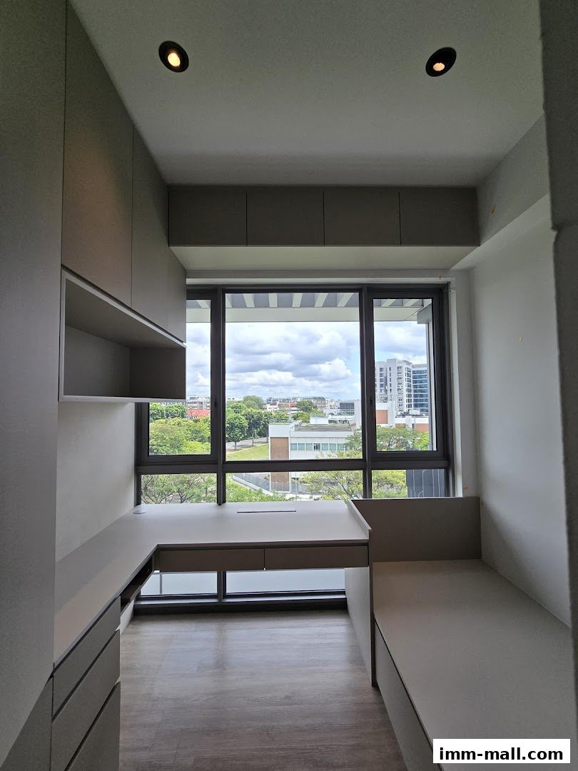 Modern built-in desk and seating area with a large window overlooking the city.