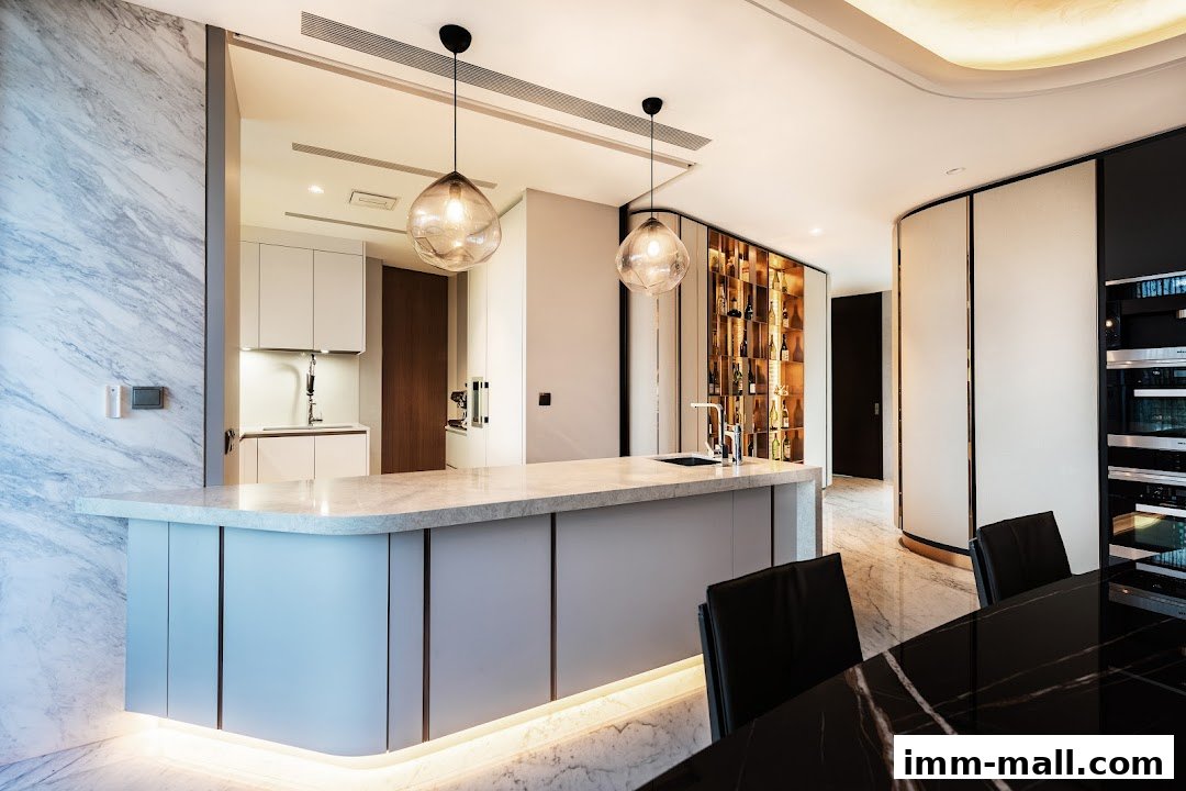 A modern kitchen and dining area with a marble island, wine display, and sleek appliances.