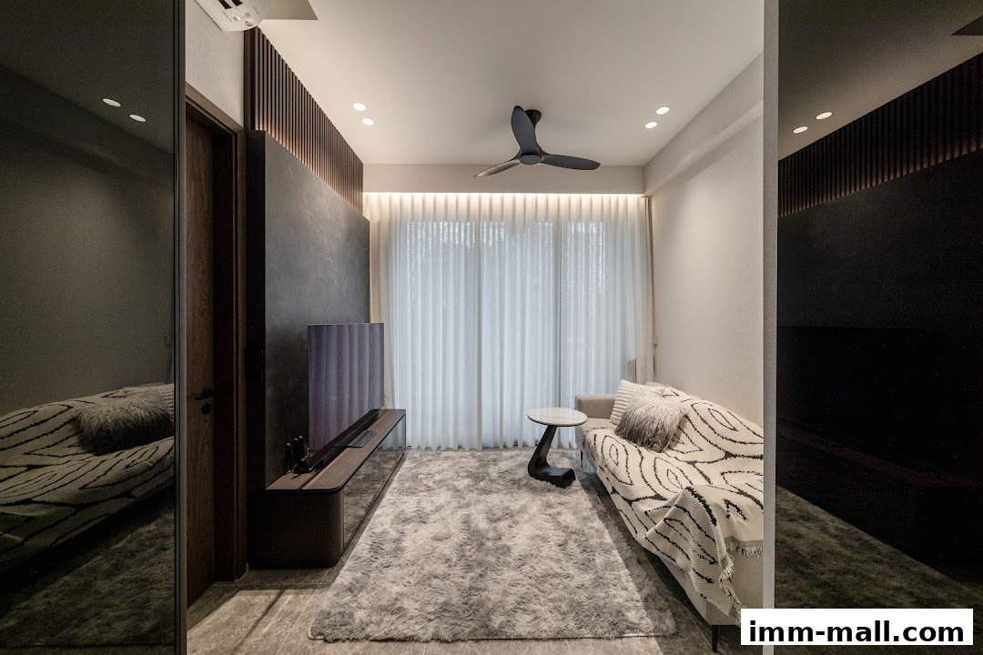 A modern living room with a sofa, TV console, rug, and ceiling fan.